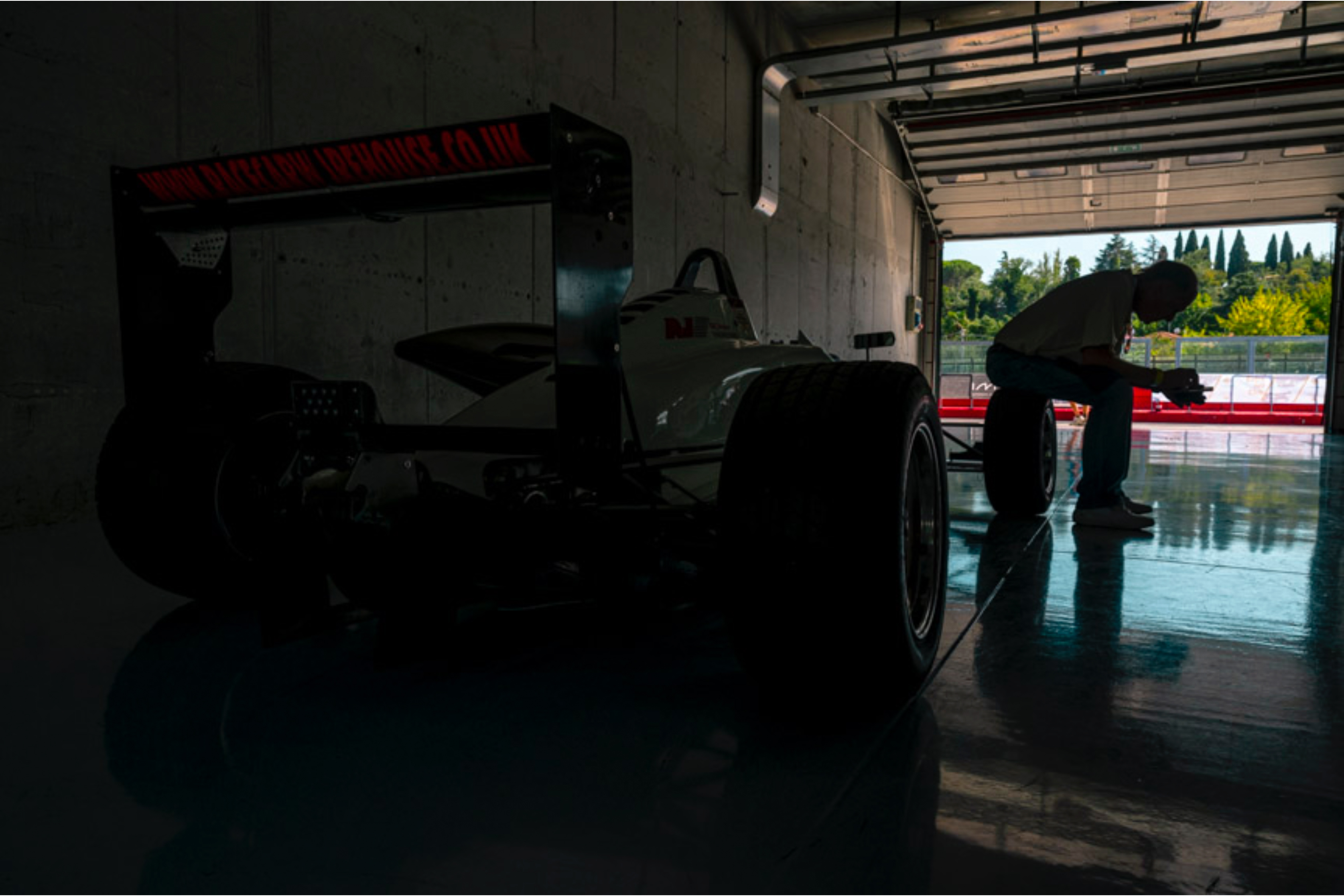 Driver and team moment before race at Minardi Day, editorial motorsport reportage by Simone Slawitz